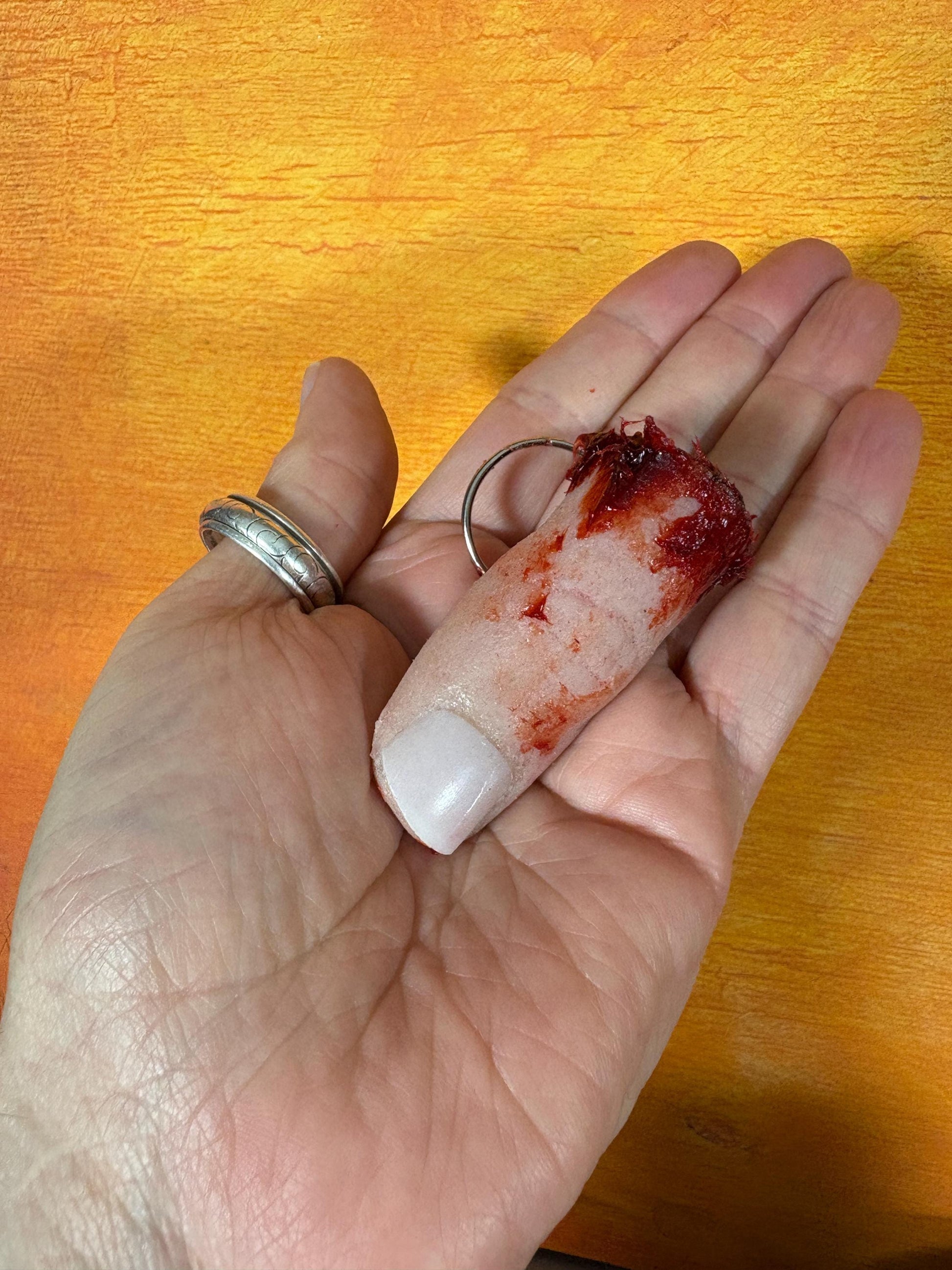 A realistic, gory severed finger keychain.